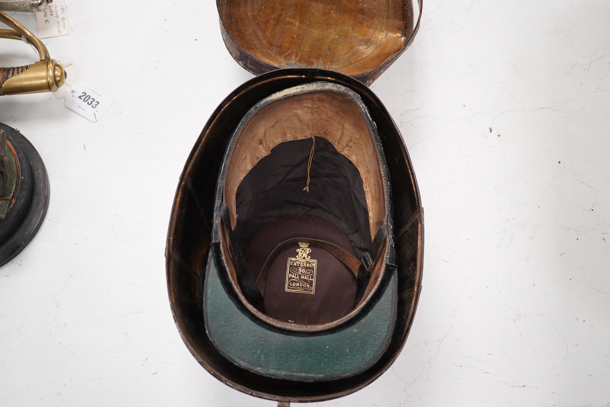 A Victorian tin cased Scottish Rifles officer's shako by Cater & Co. Pall Mall, London, with cap badge for the Cameronians, Applied plaque to lid engraved R. Robertson Esq. 2nd Scottish Rifles. Condition - fair to good,